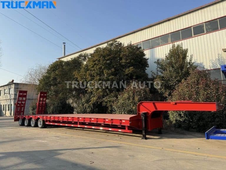 Red low-bed semi-trailer outside the workshop, ready for a professional maintenance and service check