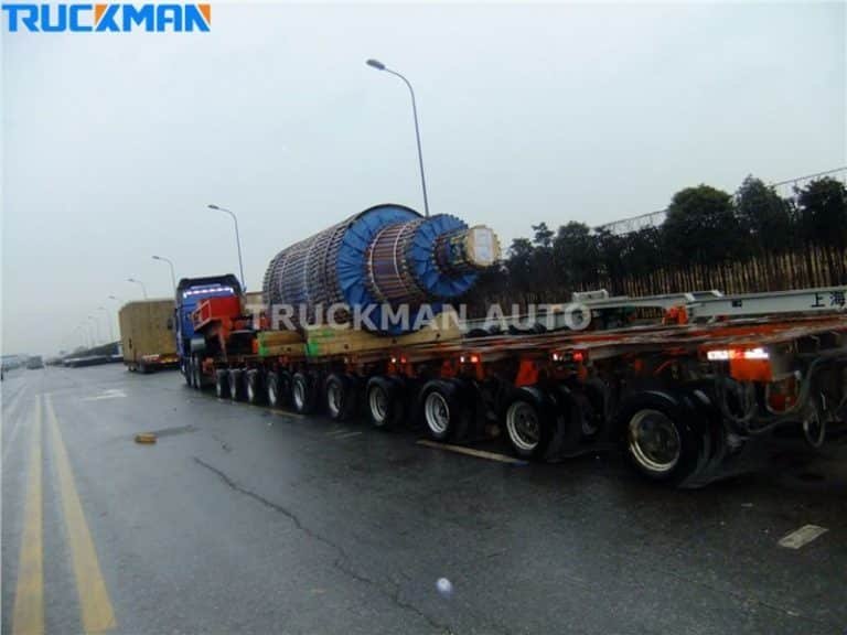 Extended low bed semi-trailer carrying a massive industrial coil