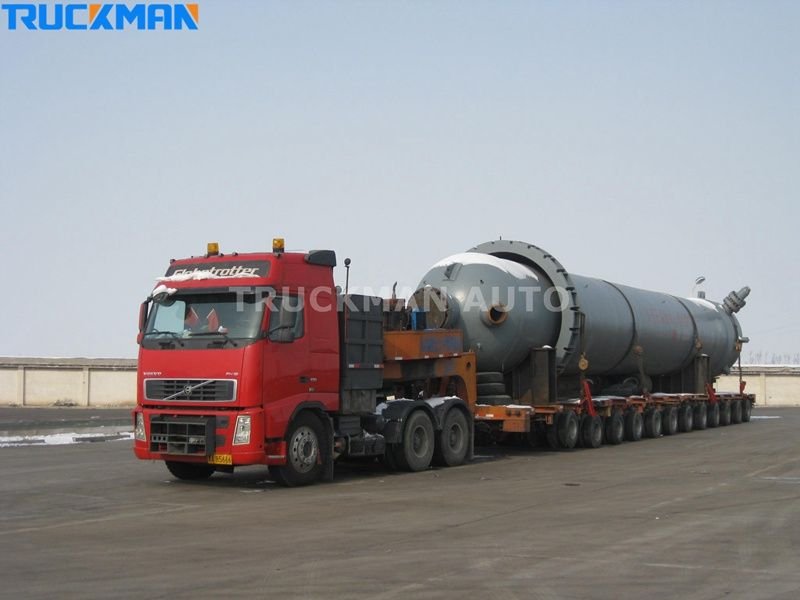 Heavy-duty Volvo low-bed semi-trailer transporting large cylindrical tanks - high load capacity