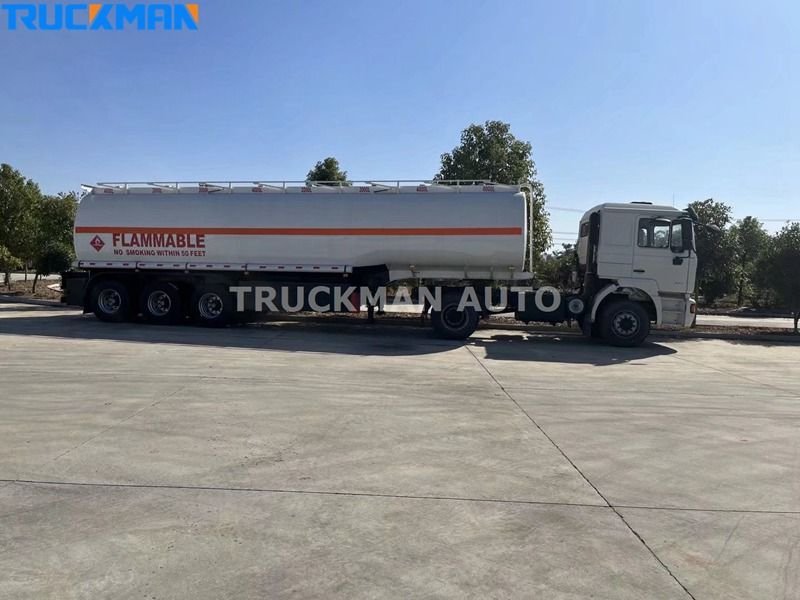 White fuel tanker trailer parked on concrete with 'Flammable' warning signs, by Truckman Auto