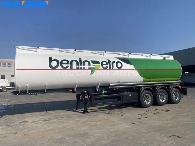 White tank trailers parked outdoors for pre-transport maintenance checks to ensure vehicle safety