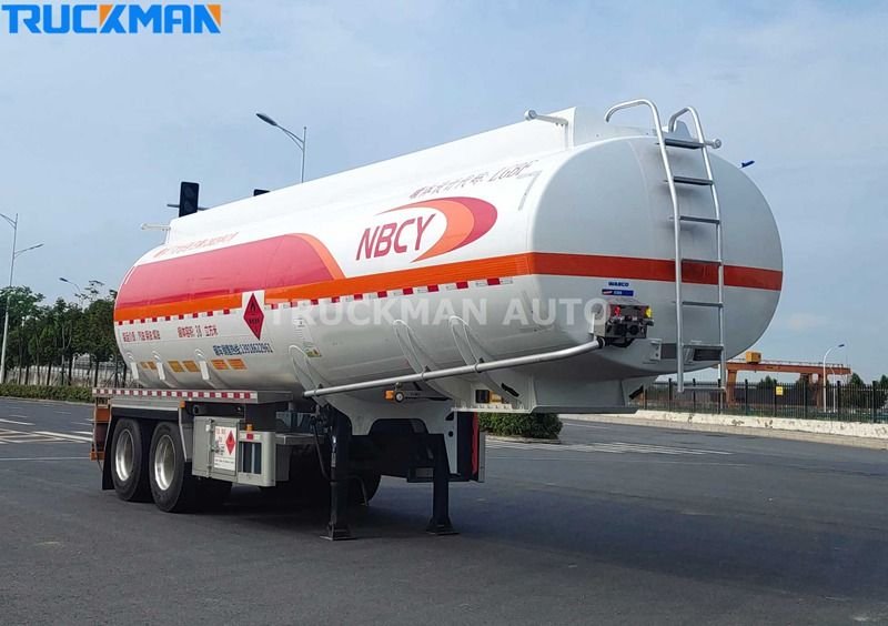 TRUCKMAN AUTO aluminum fuel tanker trailer parked on a concrete lot showcasing the rear valves and safety features with NBCY branding