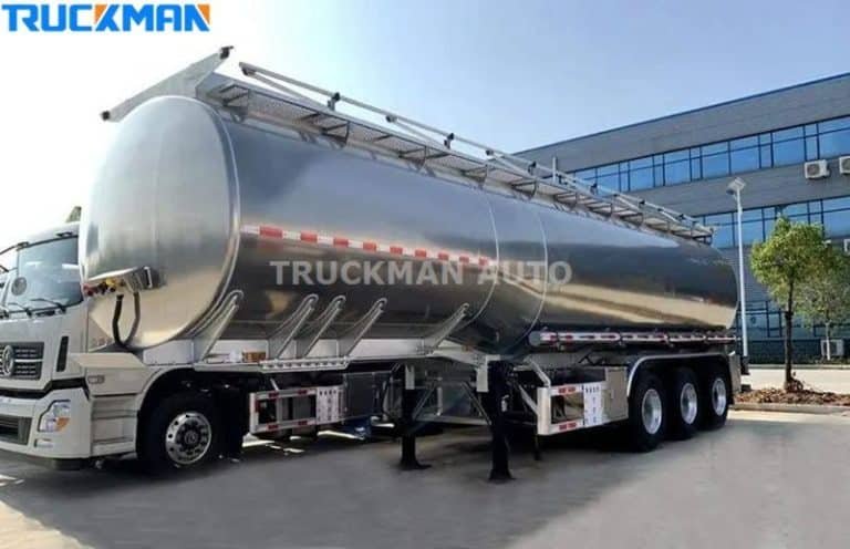 Silver oil tanker trailer attached to a tractor head, ready for transport