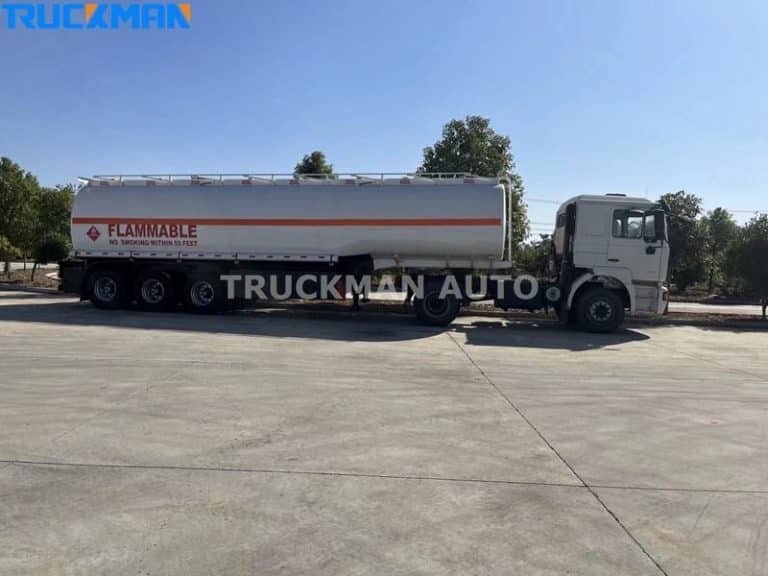 White fuel tankers with flammable logos in a spacious car park