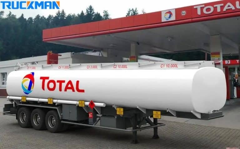 A white TOTAL branded fuel tanker trailer at a service station, highlighting its large volume capacity for petroleum product transportation