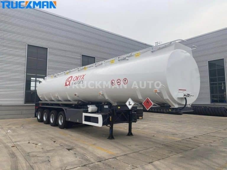 White fuel tanker ready for dangerous goods transport with safety warning signs