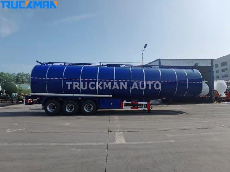 Side view of a blue oil tanker trailer by Truckman Auto, equipped for hazardous material transport