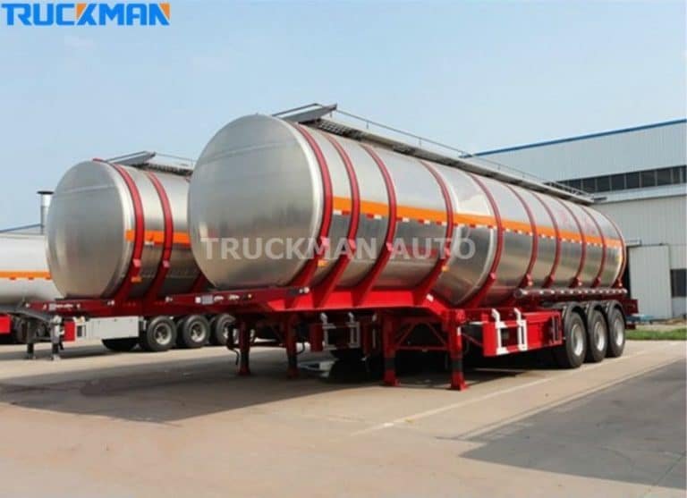 Row of red-striped stainless steel tanker trailers at Truckman Auto, designed for safe material transport.