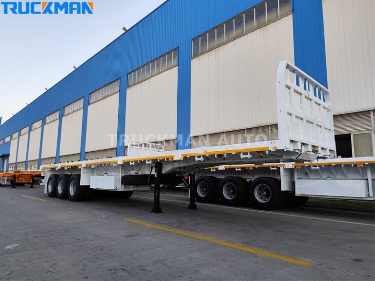 Truckman flatbed semi trailer parked outside a manufacturing facility