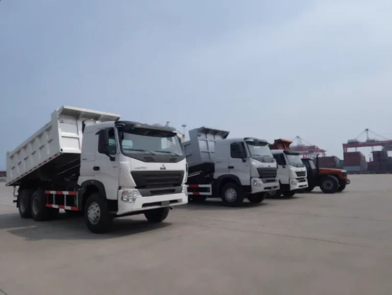 New HOWO trucks lined up at a China export yard before shipment