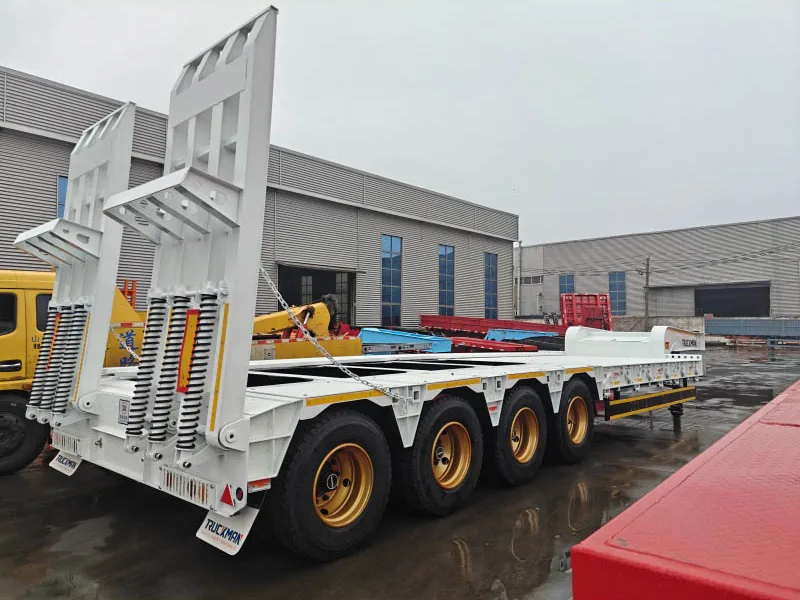 Rear three-quarter view of an 8 axle lowbed trailer with loading ramps raised